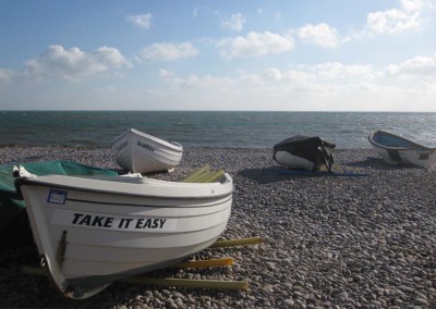 Photo: Boats on the beach at Budleigh Salterton